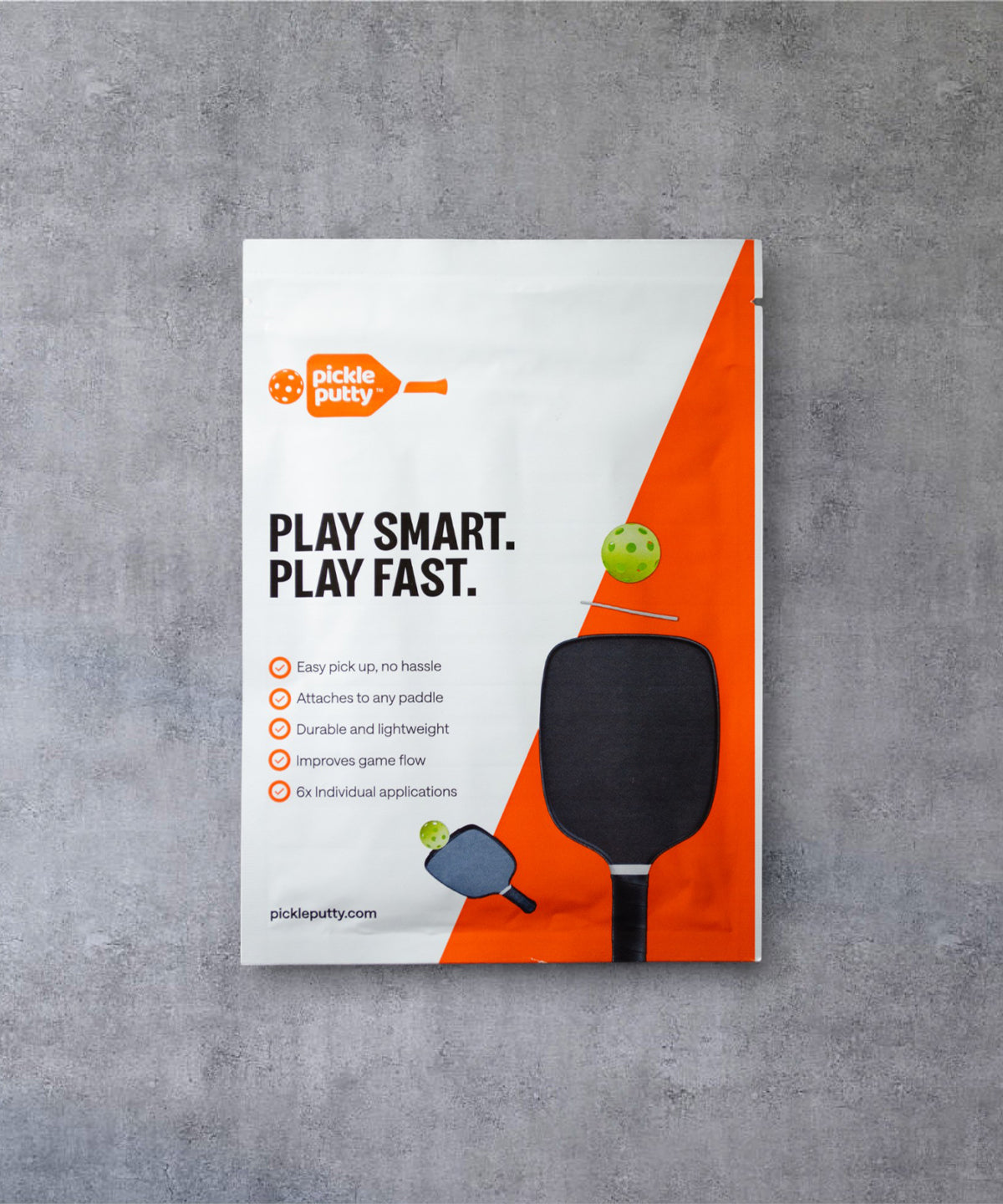 Front view of Pickle Putty packaging, a no bend pickleball ball pickup tool that sticks to any paddle.